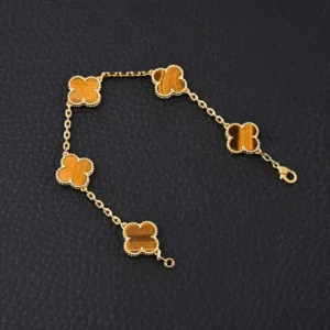 Van Cleef Arpels replica yellow gem Fritillaria four leaf clover five flower hand bracelet with gold chain and intricate detailing.