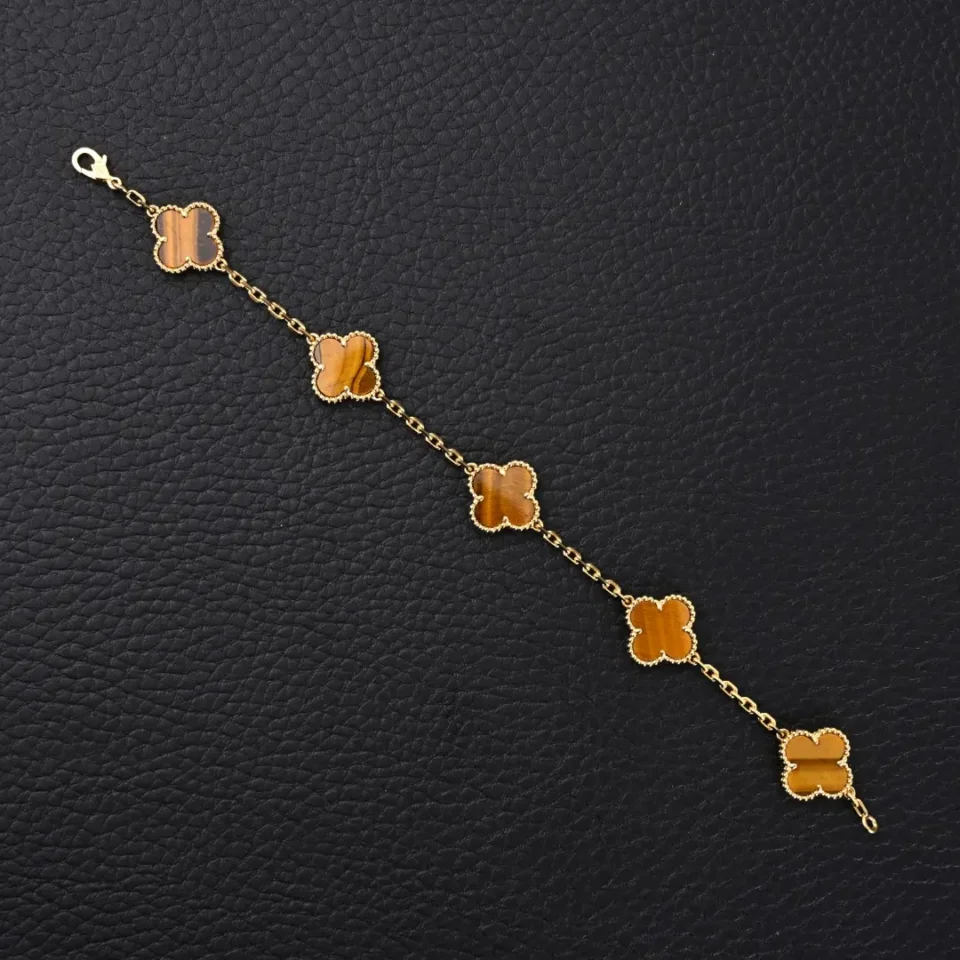 Van Cleef & Arpels Alhambra bracelet yellow gold tiger eye stone quatrefoil design accessory
