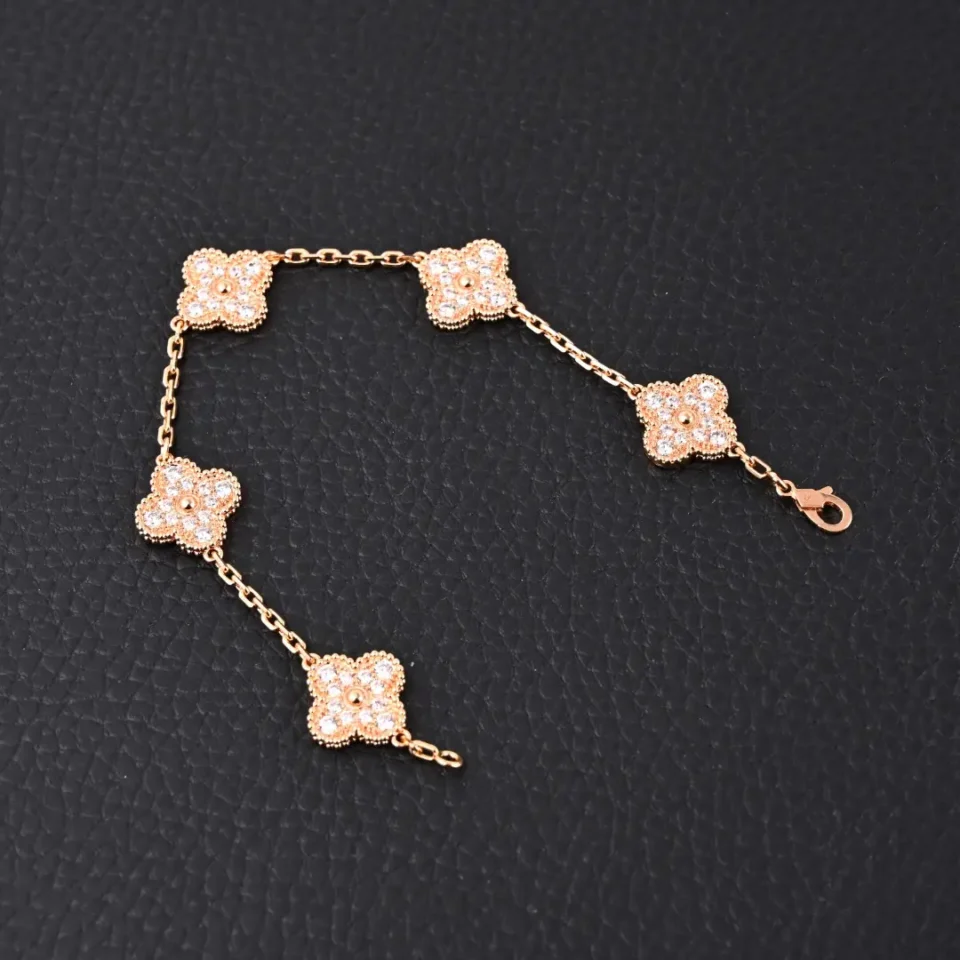 Van Cleef & Arpels bracelet rose gold floral motifs diamond accents chain jewelry