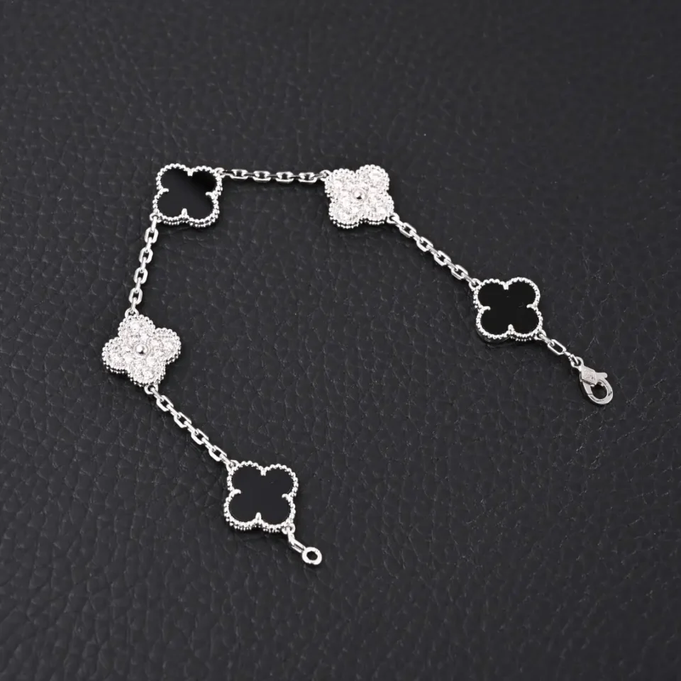 Van Cleef & Arpels Alhambra bracelet white gold black onyx clover motifs delicate chain accessory