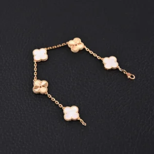 Van Cleef & Arpels-inspired gold bracelet featuring white jade intermedullary diamonds and four leaf clovers, showcasing intricate craftsmanship and unique design.