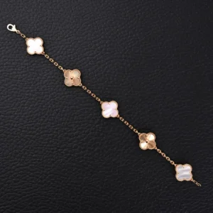 Van Cleef & Arpels-inspired white jade intermedullary diamond four leaf clover five flower hand bracelet, featuring intricate gold electroplating and exquisite craftsmanship on a textured background.