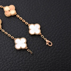 Van Cleef Arpels-inspired bracelet featuring white jade four-leaf clover and five flower design, gold electroplated chain, and intricate craftsmanship.