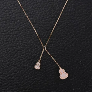 Qeelin Kirin Tassel Natural Beimu Gourd Necklace featuring pure silver electroplating, 18k gold accents, high carbon diamond inlays, and natural red agate, displayed on a textured black background.