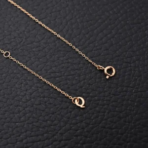 Qeelin Kirin Tassel Natural Beimu Gourd Necklace featuring delicate gold chain and clasp, set against a textured black background.