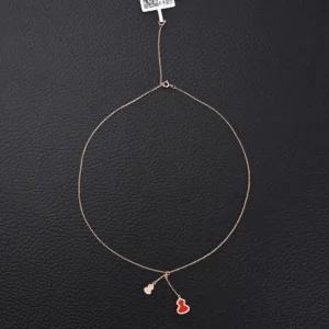 Qeelin Kirin tassel necklace featuring a red agate gourd pendant, crafted with pure silver electroplating and 18k gold process, displayed against a black background.