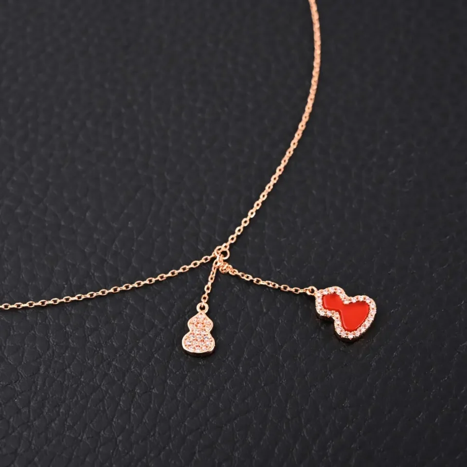 Van Cleef & Arpels pendant necklace rose gold red enamel diamond accents delicate chain accessory