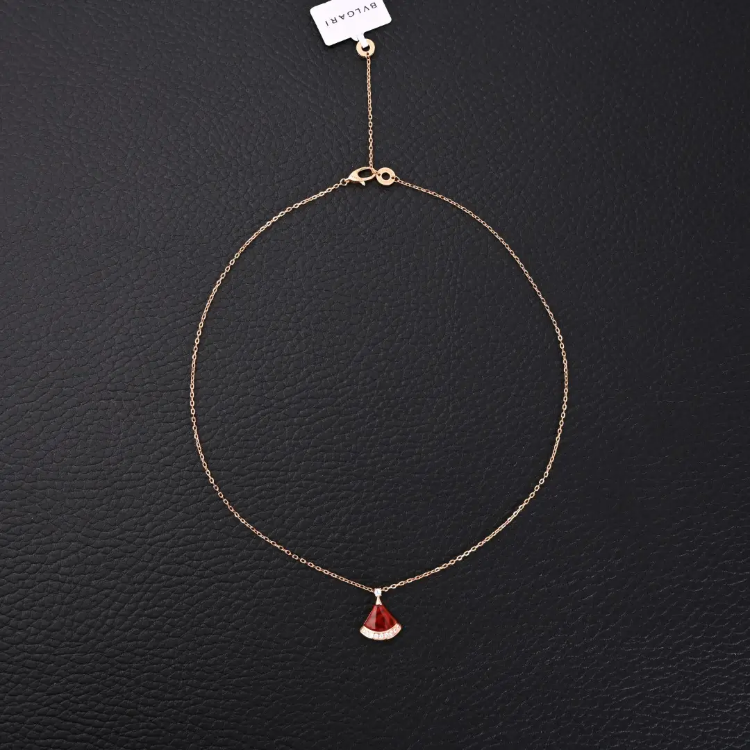 BVLGARI Diva fan-shaped necklace featuring red agate, white mother of pearl, and diamond accents on a delicate gold chain.