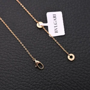 Bvlgari necklace rose gold color metal chain with circular logo pendant and lobster clasp closure