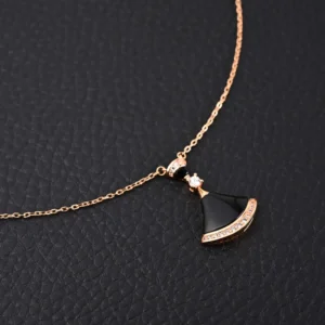 Unbranded necklace black pendant rose gold chain with crystal accents on black textured background