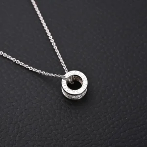 Bvlgari necklace silver chain circular pendant with engraved logo and crystal accents sterling silver material