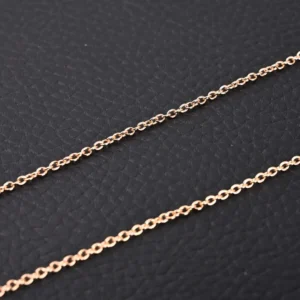 RepSGOAT chain necklace rose gold metal fine link accessory on black textured background