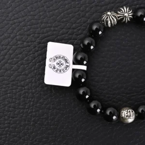 Chrome Hearts Silver Bead Obsidian Bracelet featuring black obsidian beads and silver accents, displayed on a textured black surface, highlighting luxury and style in fashion jewelry.