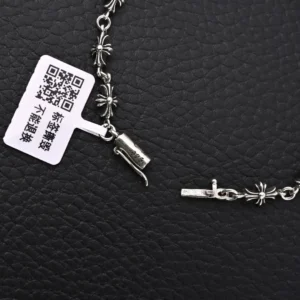 Chrome Hearts Diamond Free Fine Cross Flower Bracelet featuring floral designs and a clasp, displayed against a textured black background.