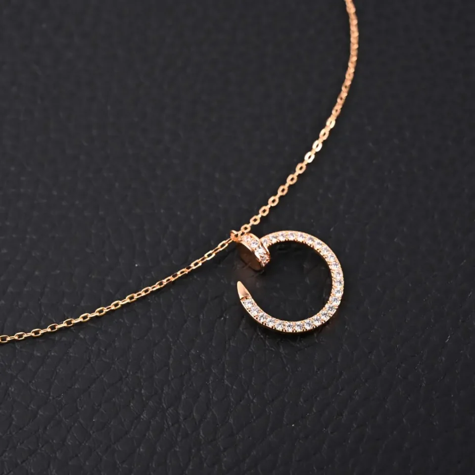 Unknown brand gold necklace with circular pendant encrusted with small clear crystals on chain