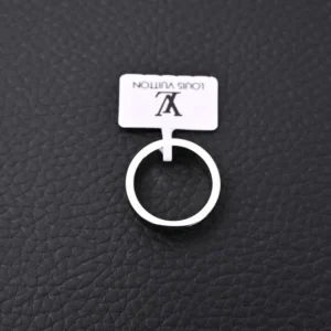 Louis Vuitton LV X Nigo co-branded enamel ring displayed on textured black surface with tag.
