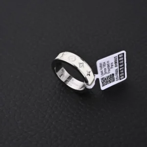 Louis Vuitton LV x Nigo co-branded enamel ring displayed on a textured black surface, featuring engraved logos and a price tag indicating .00.
