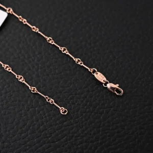 Chrome Hearts double cross pendant necklace chain detail, showcasing intricate links and clasp on a textured black background.