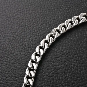 Louis Vuitton Black Enamel Cuban Silver Necklace featuring a shiny silver chain against a textured black background, highlighting luxury and modern design elements.