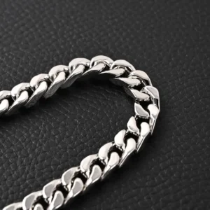 No brand or model information visible to generate SEO-optimized alt text for this silver chain accessory on black textured background