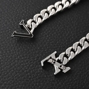 Louis Vuitton cufflinks silver metal shiny chain link with LV logo on black textured background