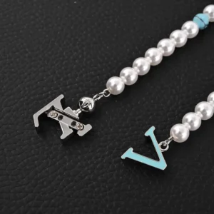 Louis Vuitton LV Turquoise Logo Letter Metal bracelet featuring turquoise and pearl beads, showcasing the iconic LV logo and elegant design elements.