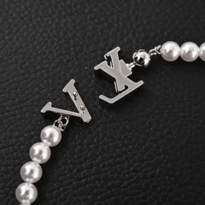 Louis Vuitton LV Turquoise Logo Letter Metal bracelet featuring pearl beads and silver logo accents, showcasing luxury fashion design elements.