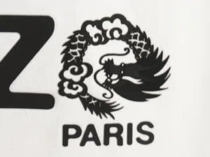 Kenzo logo black dragon emblem on white fabric background