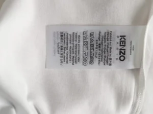 Kenzo Paris clothing label white fabric care tag made in Portugal with washing instructions