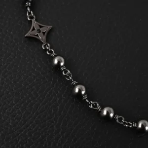 Louis Vuitton bracelet black metal chain with round beads and star-shaped charm accessory