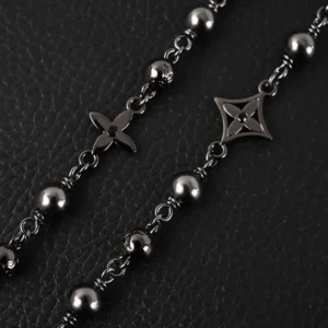 Louis Vuitton necklace gunmetal color metal beads and monogram flower charm accessory