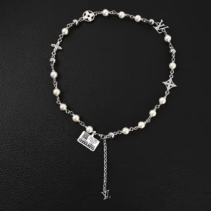 Louis Vuitton LV Pearls DA necklace featuring Damier engraved metal beads, silver-tone chain, and logo decorations interspersed with white pearls, showcasing a classic luxury accessory design.