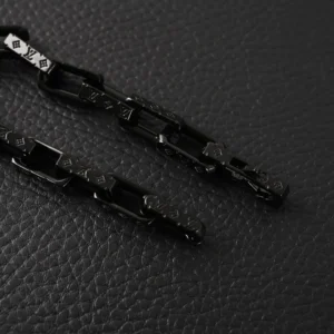 Black quenched bamboo necklace featuring Louis Vuitton logo and titanium steel chain links, displayed on textured black surface.
