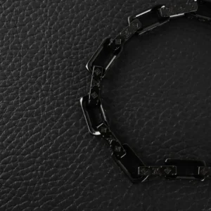 Black quenched bamboo necklace with titanium steel chain links, featuring engraved Louis Vuitton logo, displayed on textured black surface.