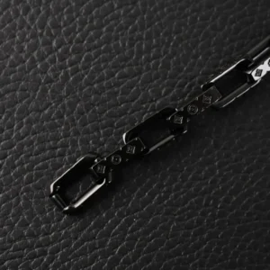 Black quenched bamboo necklace chain link featuring engraved Louis Vuitton logo on textured black background.