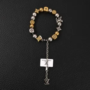 Louis Vuitton LV Damier Party antique gold bead bracelet with mixed metal beads and logo charms on a black background.