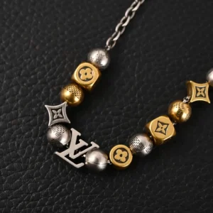 Louis Vuitton antique gold bead bracelet featuring silver and gold beads, LV logo charm, and elegant design, representing a replica luxury accessory.