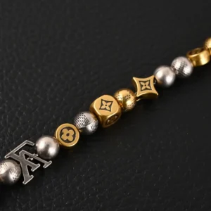 Antique gold and silver bead bracelet featuring Louis Vuitton logos and decorative elements, representing the Louis Vuitton LV Damier Party replica.