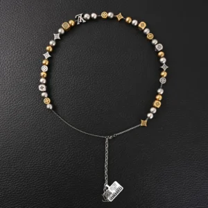 Louis Vuitton LV DamierPar necklace featuring antique gold and silver beads, showcasing luxury design elements on a black background.