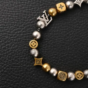 Louis Vuitton LV DamierPar necklace featuring antique gold and silver beads with iconic logo accents on a textured black background.