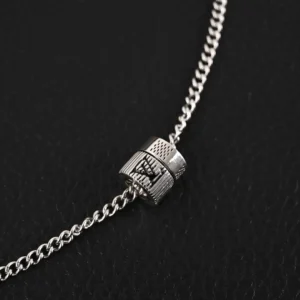 Louis Vuitton Damier Rings necklace featuring engraved LV letters and Damier pattern on a lustrous brass chain with an adjustable buckle.