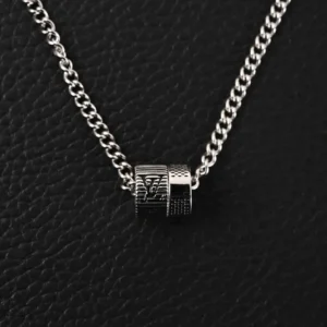 Louis Vuitton Damier Rings necklace featuring engraved LV letters and Damier patterns on a silver chain, set against a textured black background.