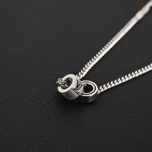 Louis Vuitton Damier Rings necklace featuring lustrous brass, engraved LV letters, and Damier patterns, adjustable buckle on silver chain.