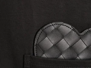 Bottega Veneta heart-shaped black leather accessory with woven texture and stitching detailing