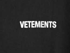 Vetements logo printed in white on a black round neck T-shirt, emphasizing designer brand identity for premium replica fashion.