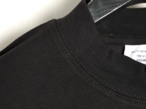 Vetements black cotton crewneck t-shirt close-up of collar stitching and fabric texture