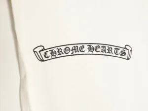 Chrome Hearts logo on white hoodie showcasing brand identity and design details.