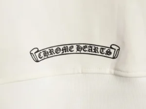 Chrome Hearts logo on a white hoodie, showcasing brand identity and design elements.