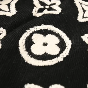 Louis Vuitton knitwear black fabric white monogram floral pattern textured material close-up
