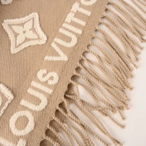 Louis Vuitton 3D Embossed Logo Wool Tassel Long Scarf featuring the brand name and logo, with fringed edges, displayed in a beige color.